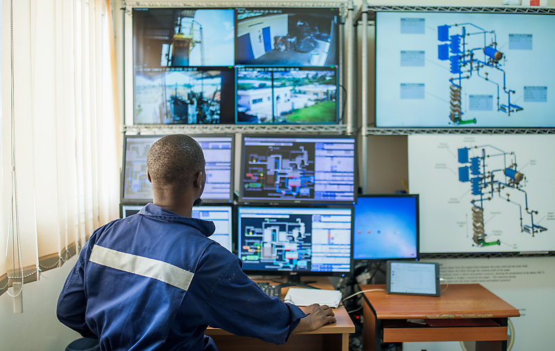 Seated in front of a computer screen, a technician controls the automated system that operates the Janicki Omni Processor.