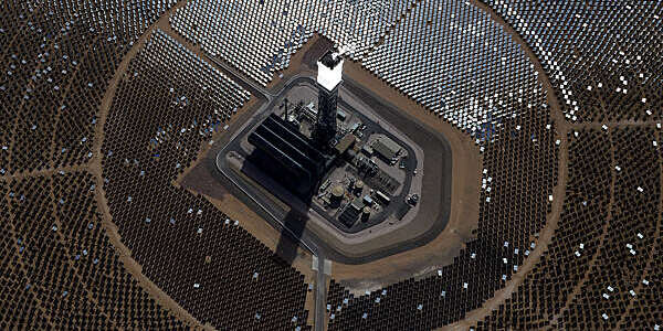 PRIMM, NV - FEBRUARY 20: The Ivanpah Solar Electric Generating System is seen in an aerial view on February 20, 2014 in the Mojave Desert in California near Primm, Nevada. The largest solar thermal power-tower system in the world, owned by NRG Energy, Google and BrightSource Energy, opened last week in the Ivanpah Dry Lake and uses 347,000 computer-controlled mirrors to focus sunlight onto boilers on top of three 459-foot towers, where water is heated to produce steam to power turbines providing power to more than 140,000 California homes. (Photo by Ethan Miller/Getty Images)