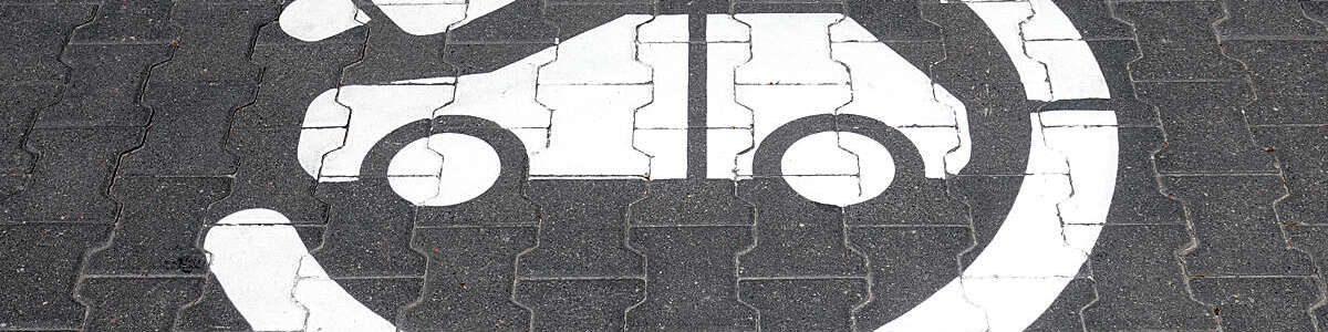 Electric charging station symbol and inscription on a street. 