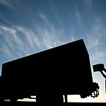 Man loading up cardboards in a truck.