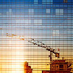 Reflection of construction work in a window building